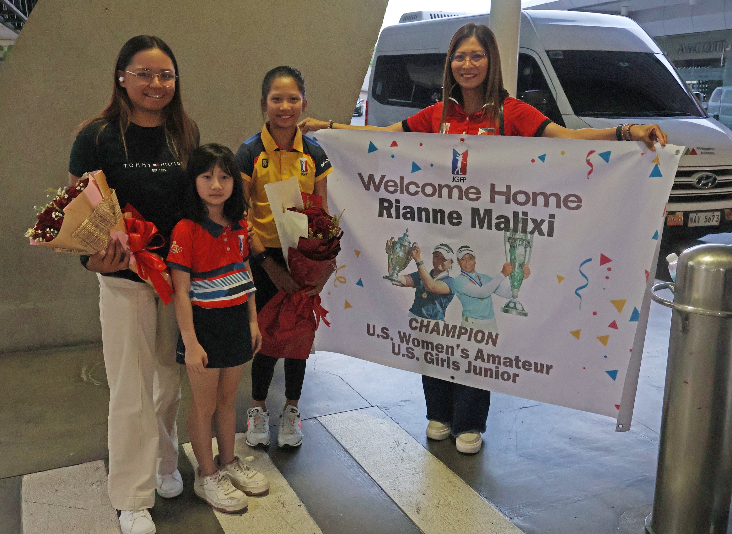 RIANNE Malixi (left) gets a warm welcome from Junior Golf Federation of the Philippines director Mariel Macasaet and junior golfers Nicole Gan and Brianna Macasaet upon her arrival at the Ninoy Aquino International Airport on Thursday morning.